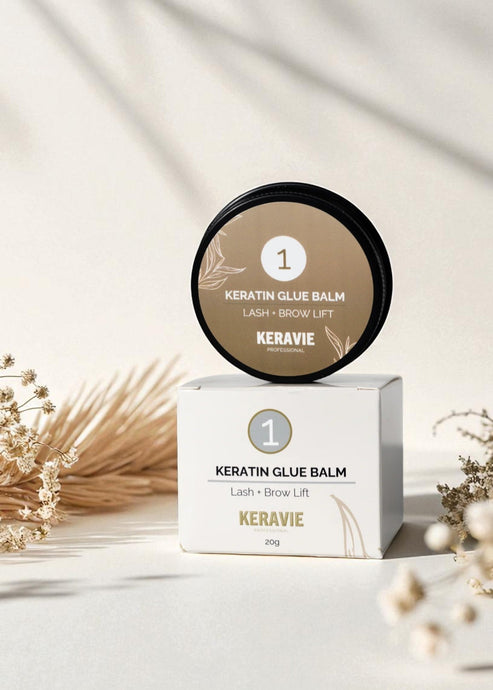 Keravie Keratin Glue Balm container and packaging on a light background with decorative elements.